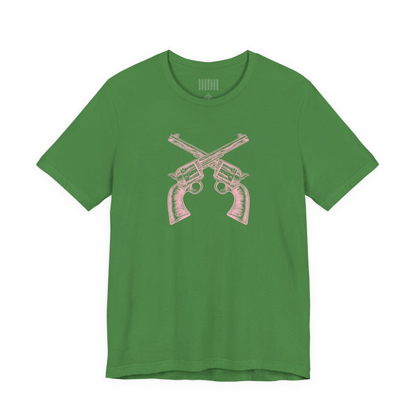 Green outlaw t shirt with vintage pink crossed pistols graphic, unisex fit, soft cotton material.