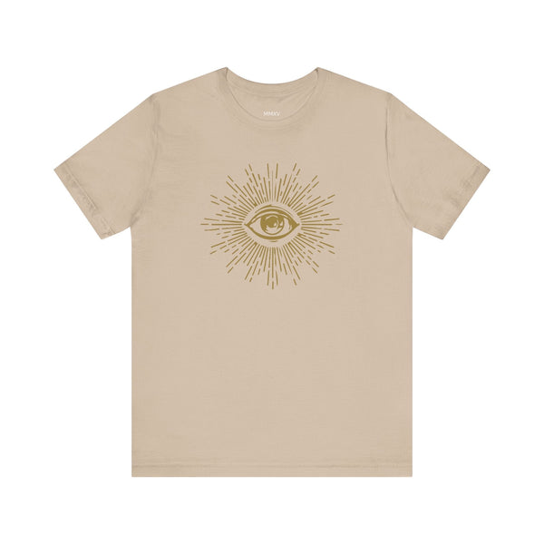 Beige unisex t-shirt featuring a gold third eye graphic with radiant energy rays, made from breathable cotton for spiritual and stylish wear.