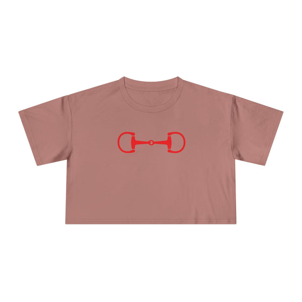 Pink cropped tee with bold red horsebit emblem, relaxed drop-shoulder fit, and soft cotton fabric.