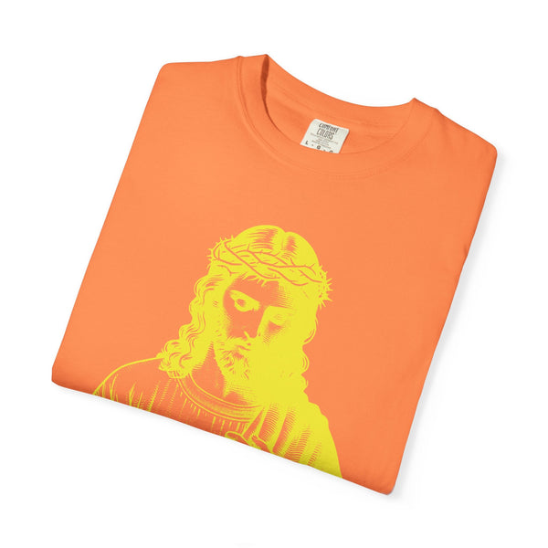 Folded orange religious graphic tee featuring a bright yellow Jesus with crown of thorns print