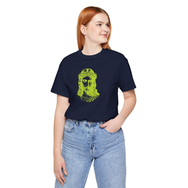 Woman wearing navy christian graphic t-shirt with bold lime green Jesus face design and blue jeans