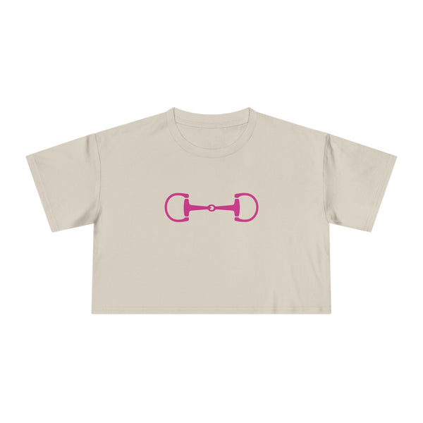 Cropped beige tee with bold pink horsebit graphic in modern equestrian style, made from soft breathable cotton, boxy fit with shorter hem.