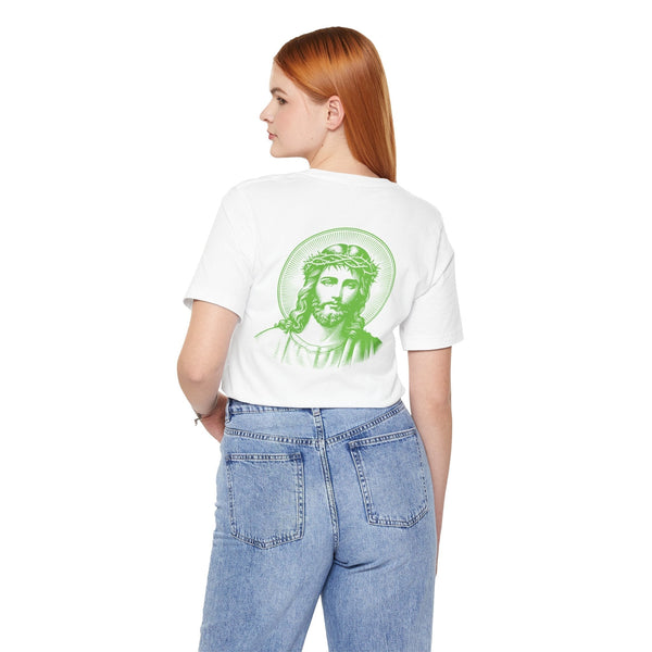 Woman wearing white Jesus graphic tee with green halo print on back and mini front design, paired with blue jeans