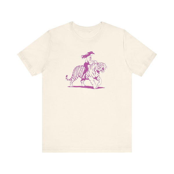 Off-white tee with neon magenta graphic of a cowgirl riding a tiger, retro style design on front.