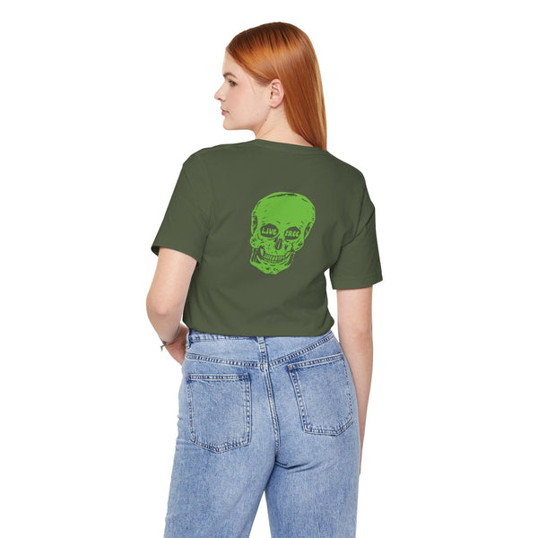 Woman wearing green skull print streetwear t-shirt with bold green back skull "Live Free" design and blue jeans.