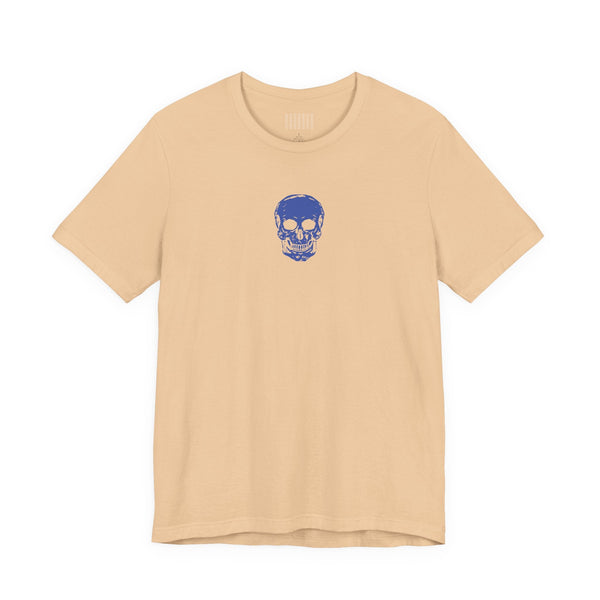 beige graphic t shirt with small blue skull design centered below collar