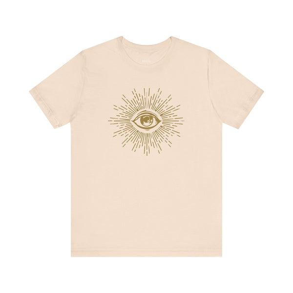 Beige unisex tee shirt with a gold third eye graphic and radiant rays design, made from breathable cotton.