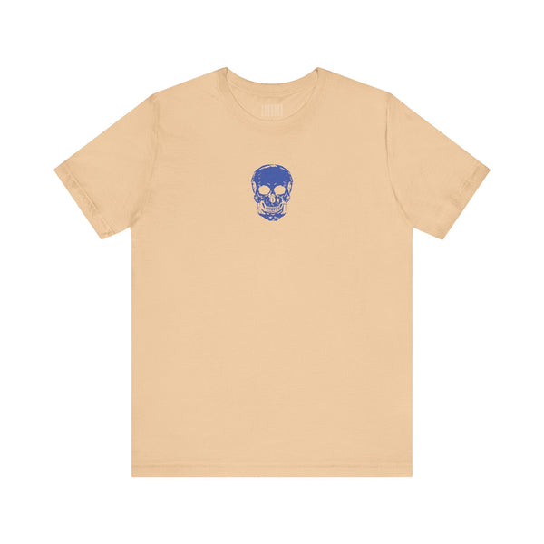 Beige graphic t shirt with small blue skull design centered below the collar