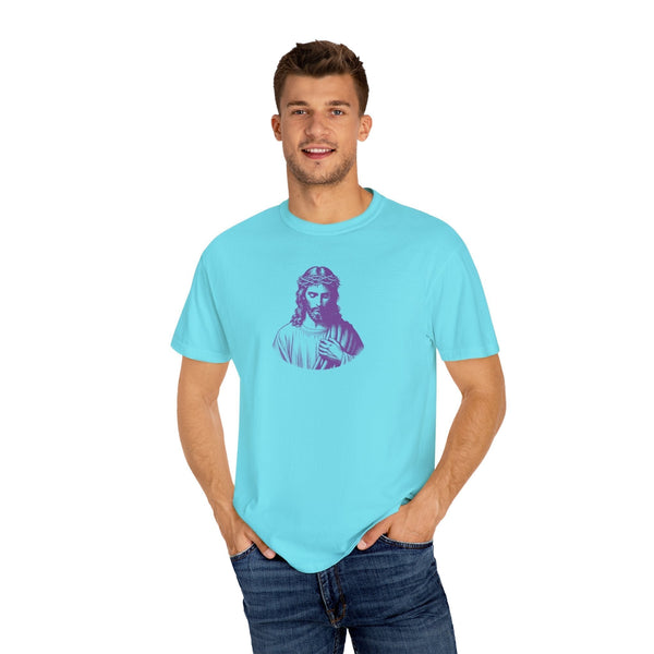 Man wearing a light blue Fugitive Tees graphic t-shirt featuring a purple mid-scale Jesus front print.