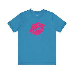 Blue unisex t-shirt with neon pink lip print graphic on front and "Fugitive." text graphic on back, made of soft cotton.