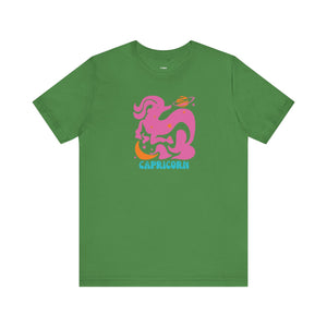 Green Capricorn astrology t shirt with vibrant pink and orange retro sea-goat graphic and blue Capricorn text