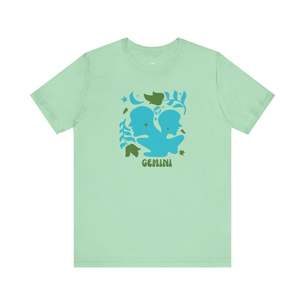 Mint green retro Gemini zodiac graphic t shirt with blue twin design and celestial accents.