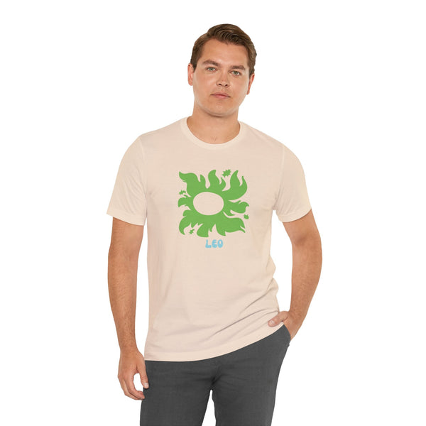 Man wearing beige Leo astrology t shirt with green sunburst and star graphic on front