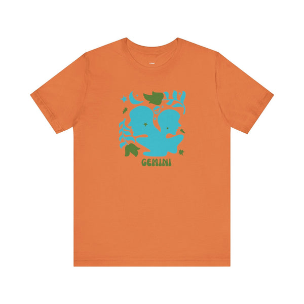 Orange retro Gemini zodiac t shirt with blue twin graphic and green leaves design