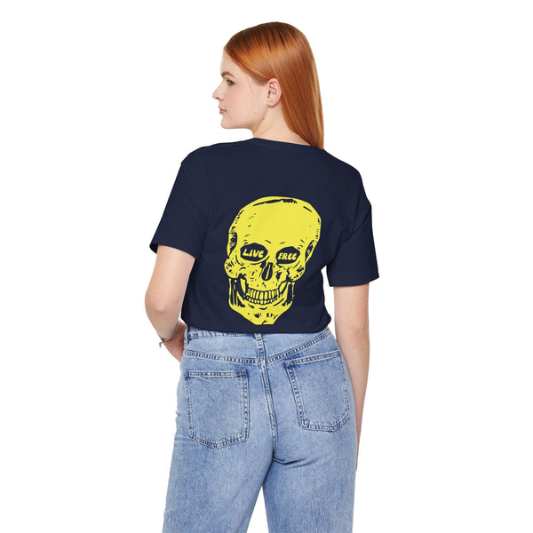 Woman wearing navy indie style tee with jumbo yellow skull and "LIVE FREE" text on back, paired with light blue jeans