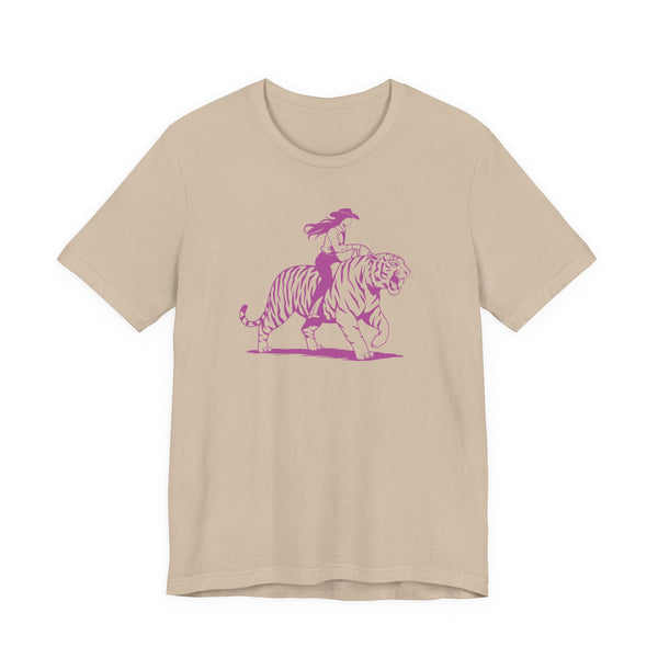 Beige unisex tee with neon magenta graphic of cowgirl riding tiger, retro style