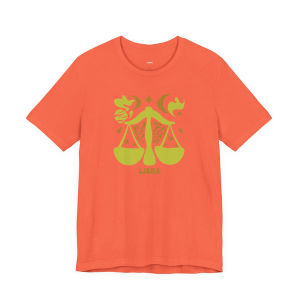 Orange Libra t shirt with green artistic zodiac balance scales graphic and celestial accents
