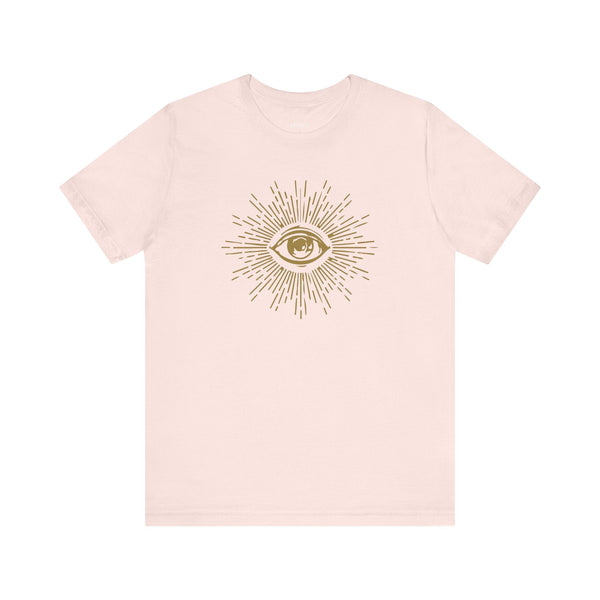 Soft pink unisex tee featuring a golden third eye graphic print on the front symbolizing vision and intuition.