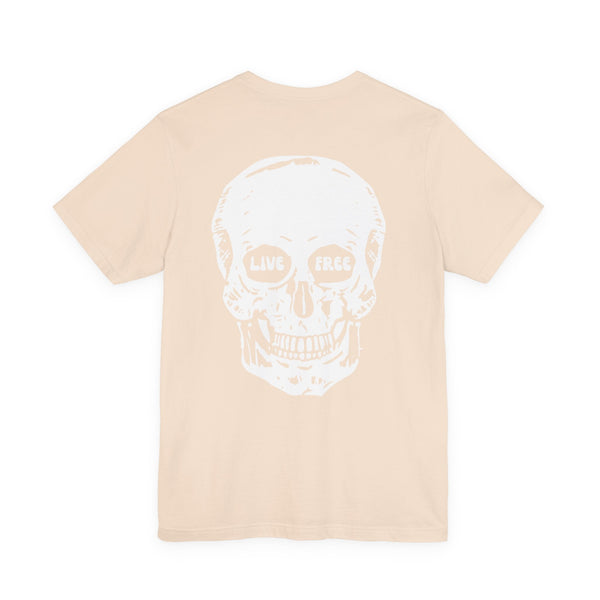 Beige streetwear t-shirt with jumbo white skull graphic on back featuring "Live Free" text in eye sockets.