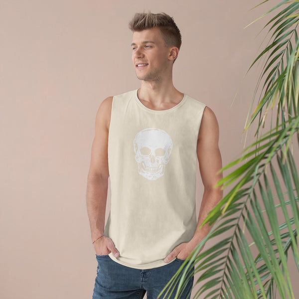 Man wearing beige skull tank top with bold front skull graphic and raw sleeve edges in casual streetwear style