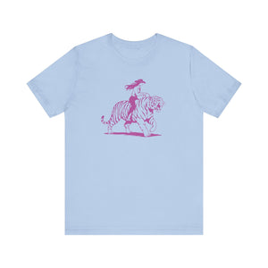 Light blue tee with neon magenta cowgirl riding tiger graphic, retro style cowgirl shirt