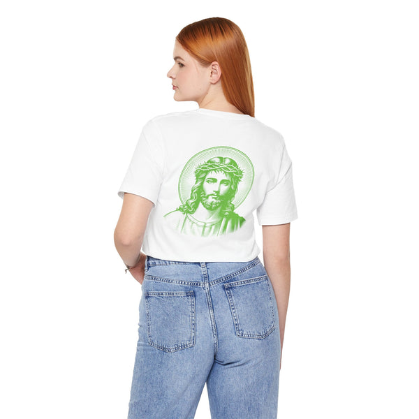 Woman wearing white Jesus graphic tee with green jumbo halo Jesus print on back and small green Jesus print on front left chest, paired with blue jeans