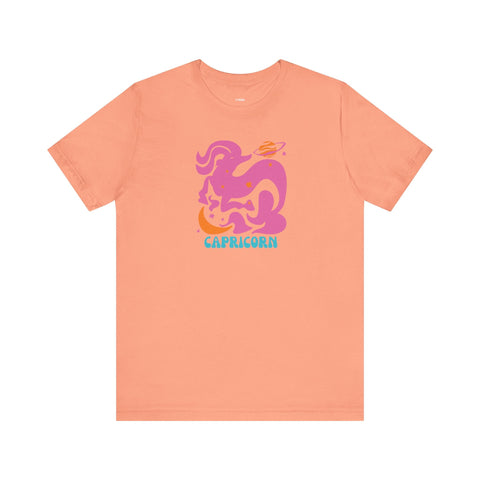 Peach Capricorn graphic tee featuring a retro pink mountain-goat design with stars, made from 100% Airlume cotton by Fugitive Tees.