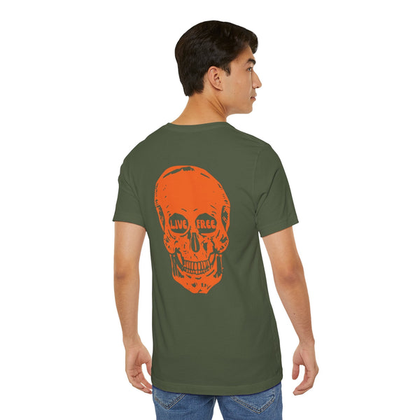 Man wearing olive green tee with large orange skull graphic on back featuring "LIVE FREE" text in eye sockets