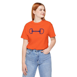 woman wearing orange stylish equestrian horsebit graphic t-shirt with regular fit and blue jeans