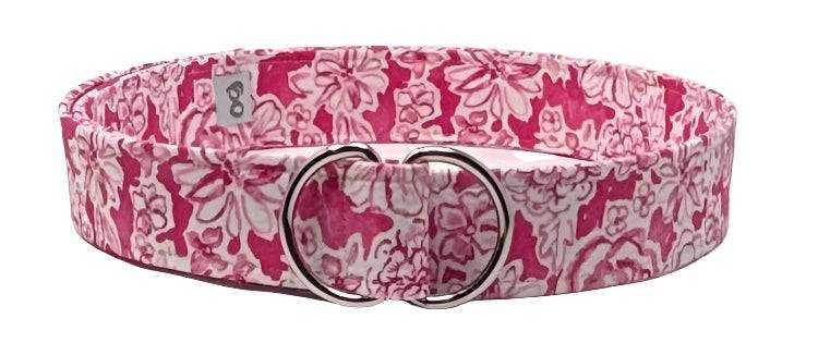 Bright pink floral fabric belt with adjustable silver D-ring closure, stylish and versatile accessory.