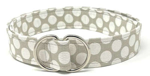 White mod polka dot D-ring belt on grey background by Oliver Green