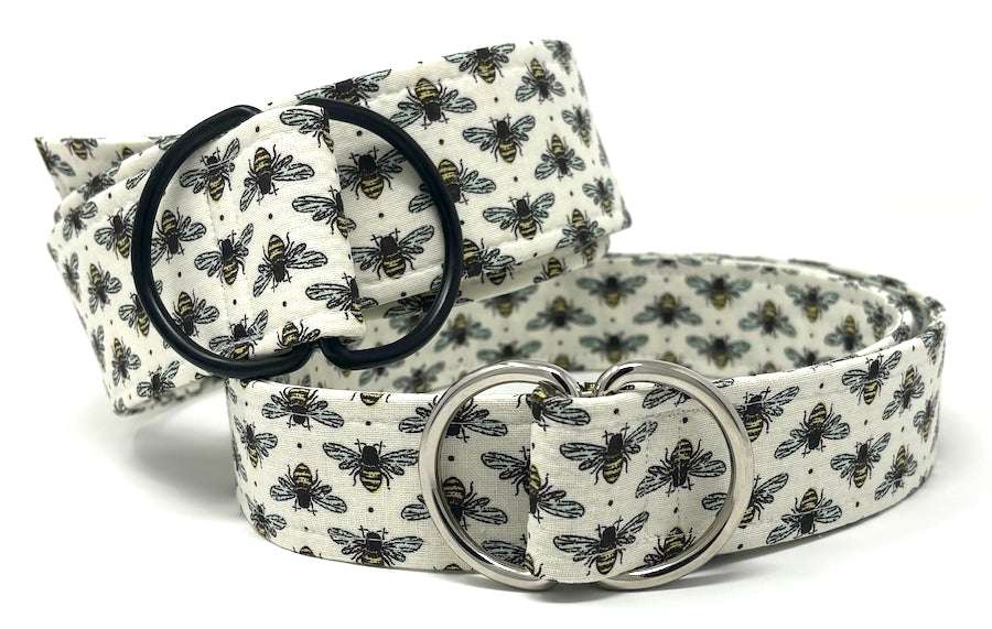 White bee-print fabric belt with black and silver D-ring buckles by Oliver Green