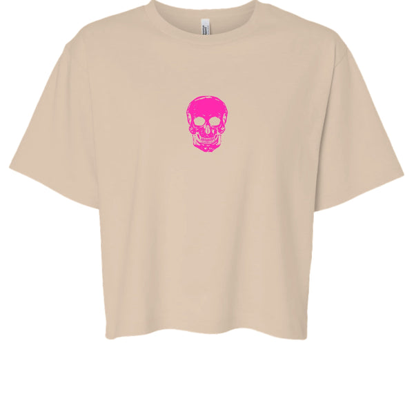 beige boxy tee with hot pink minimalist skull graphic centered on front, streetwear style