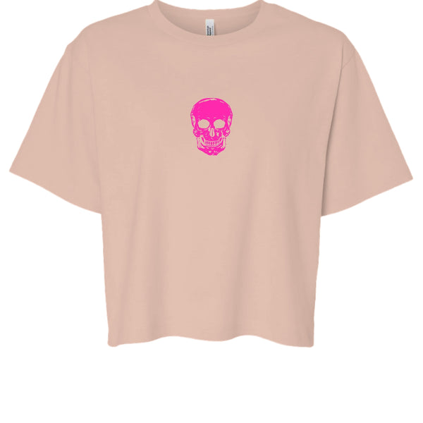 Beige boxy t-shirt with hot pink skull graphic centered on front, minimalist streetwear style
