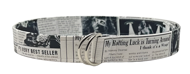 Zombie belt with newspaper print design featuring horror-themed text and imagery, 1.5 inches wide and 42.5 inches long.